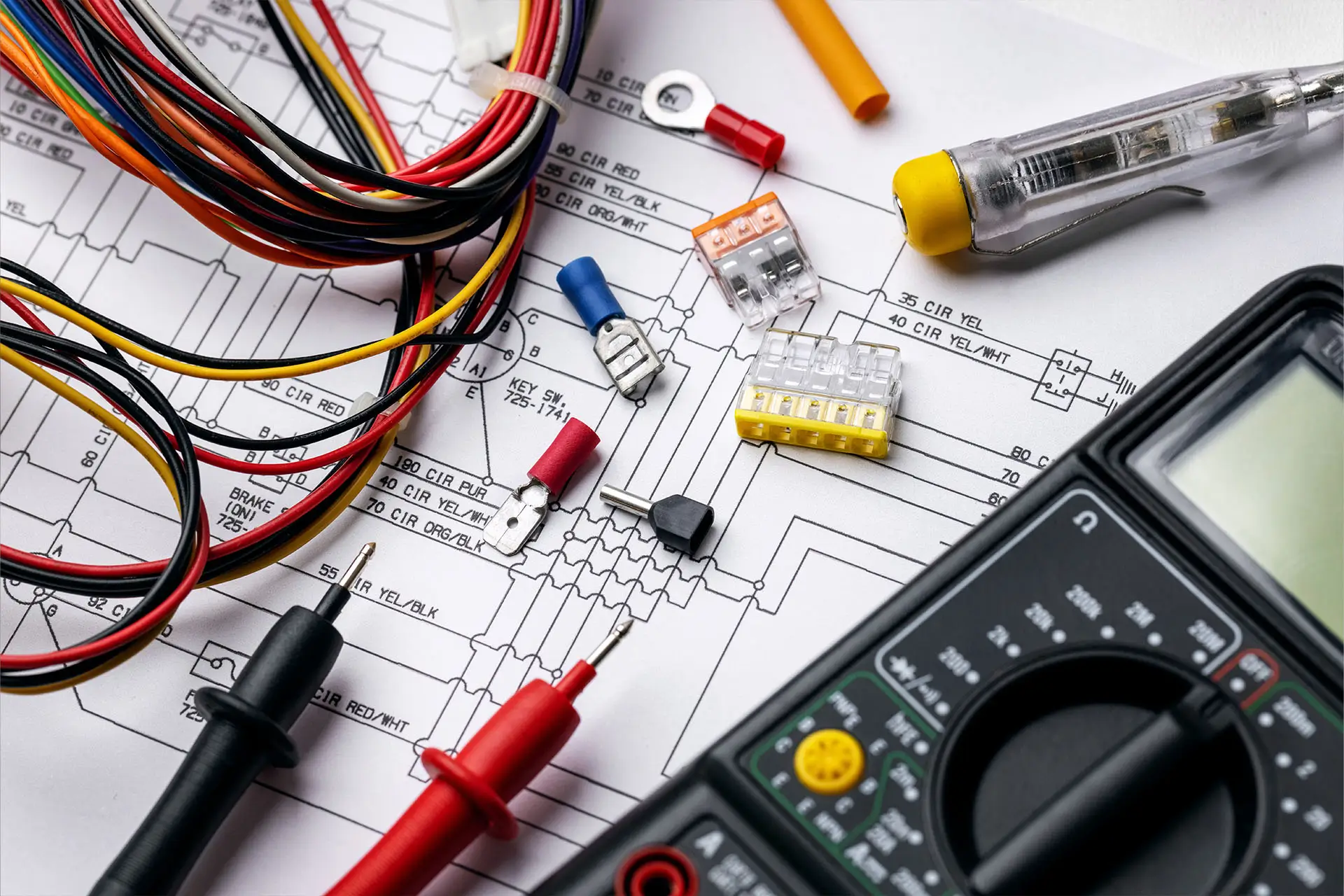 Electrician tools and electrical equipment on wiring diagram.