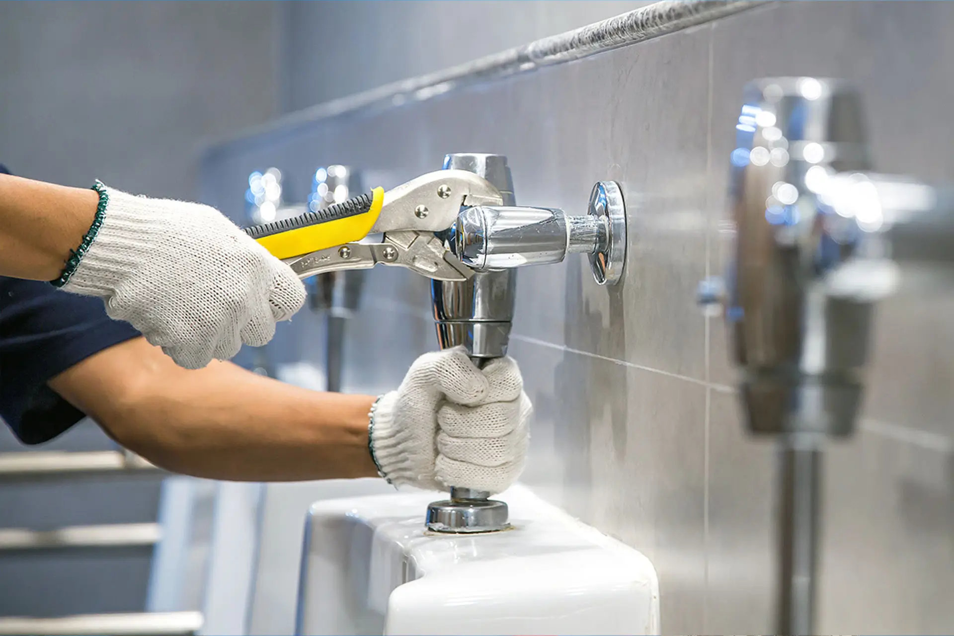 Plumber is using a wrench to fix or repair leaking water pipes.